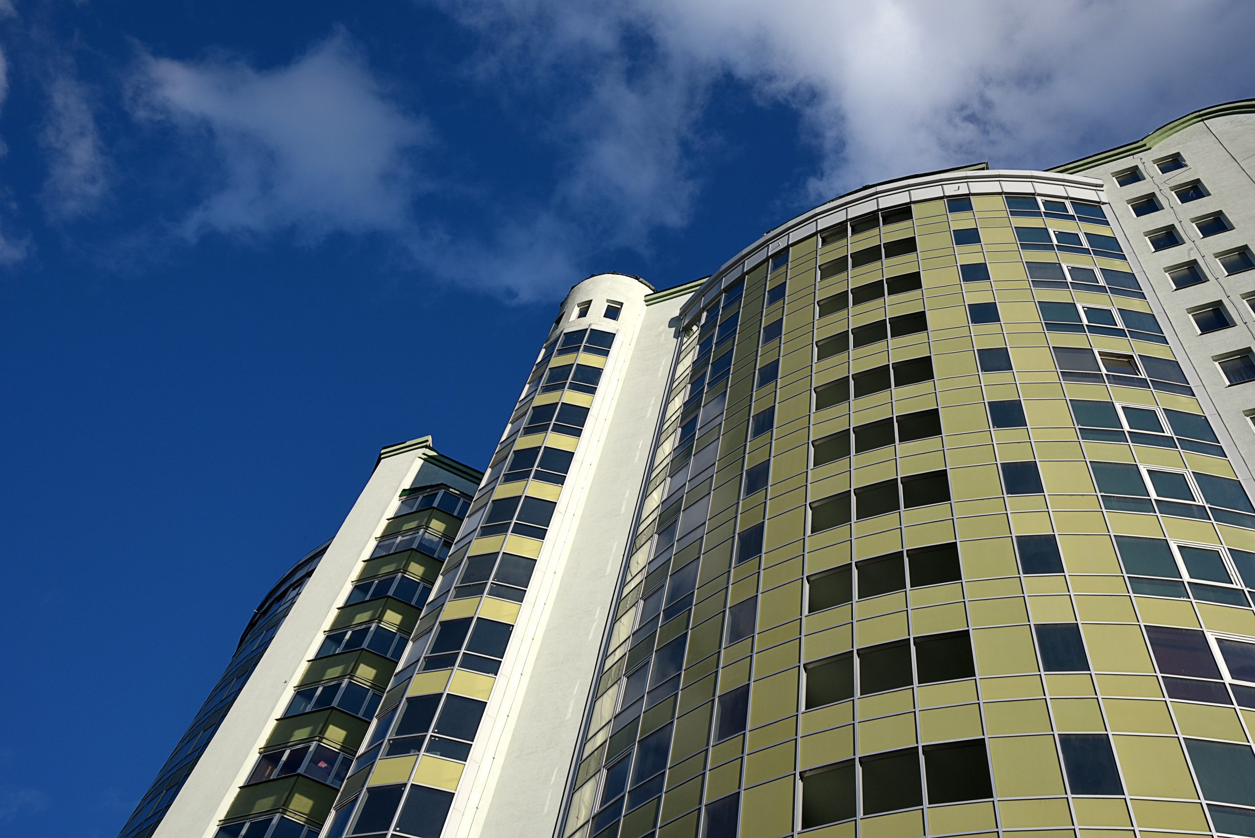 High-rise apartment building, shot from the perspective against the blue sky